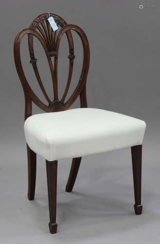 A George III Sheraton period mahogany side chair with carved decoration, the overstuffed seat raised