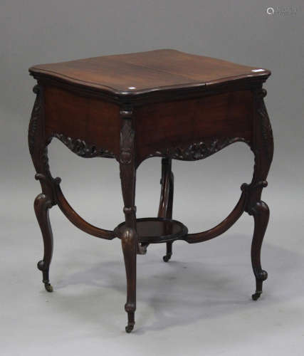 An Edwardian mahogany drinks table by Alexander Clark, London, the double-hinged top enclosing a