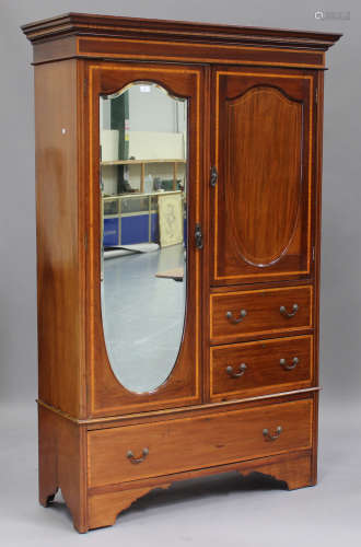 An Edwardian mahogany and satinwood crossbanded wardrobe, fitted with a full-length mirror, the base