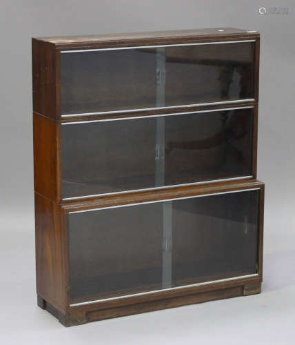 A mid-20th century mahogany three-section 'Minty' bookcase with glazed sliding doors, height