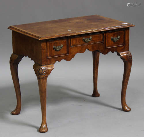 A late 19th century George II style walnut side table, the crossbanded top above three drawers,