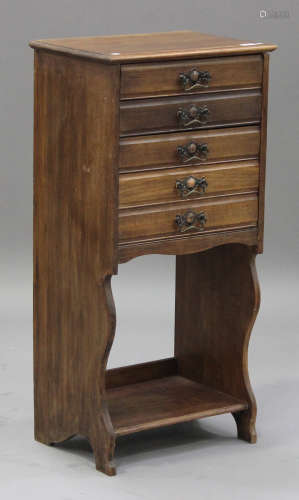 An Edwardian walnut music chest, fitted with five drawers above an open shelf, on shaped supports,