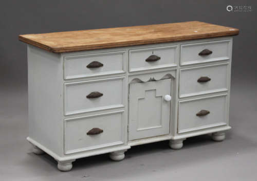 A Victorian style pine and white painted dresser base, fitted with seven drawers and a cupboard,