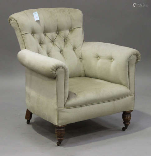 An Edwardian buttoned back scroll armchair, upholstered in green velour, on turned legs, height
