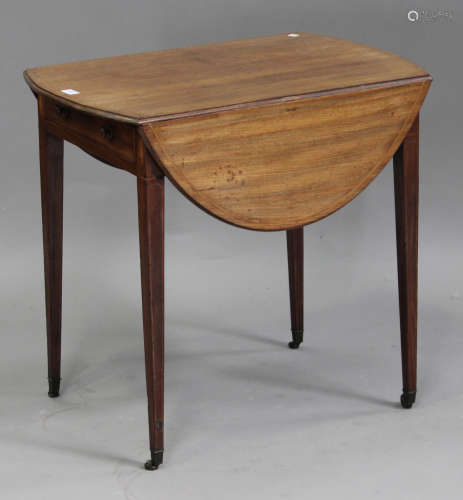 A George III mahogany oval Pembroke table with boxwood stringing, fitted with a drawer, raised on