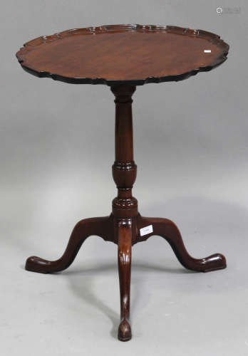 A George III mahogany circular tip-top wine table, the carved piecrust top raised on a turned column