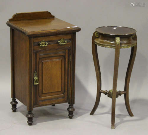 An Edwardian walnut bedside cabinet, fitted with a drawer and cupboard, on turned feet, height 73cm,