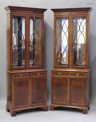 A pair of late 20th century reproduction burr walnut bookcase cabinets, each fitted with a pair of