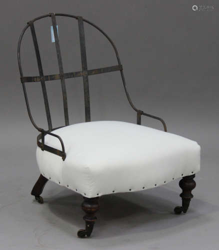 A Victorian part-upholstered iron hoop back nursing chair, the seat upholstered in calico, raised on