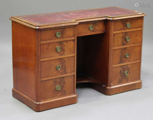 An early Victorian mahogany kneehole desk, the inverted breakfront top inset with a gilt-tooled