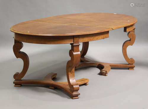 A 20th century French oak extending dining table, the oval top with a single extra leaf, raised on
