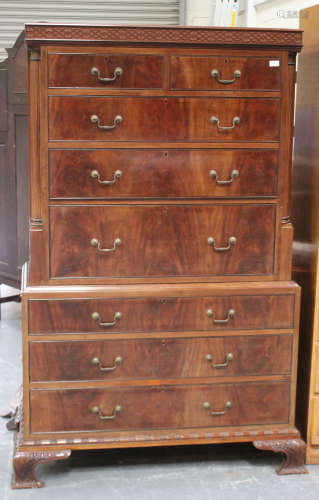 A early 20th century George III style mahogany chest-on-chest, the blind fretwork frieze above two