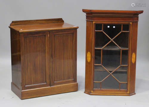 An Edwardian mahogany side cabinet with boxwood stringing, fitted with two panel doors, on a