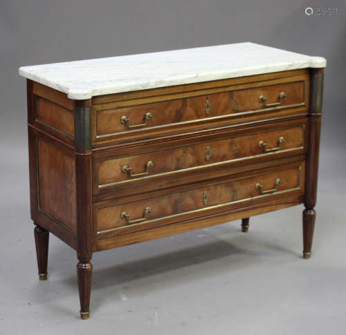 An early 20th century French Louis XVI style figured mahogany and brass mounted commode chest, the