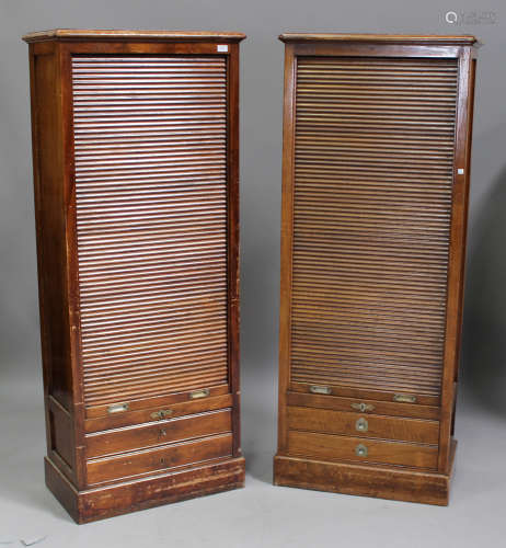 A near pair of early 20th century Continental walnut tambour fronted side cabinets, fitted with
