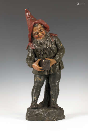 An early 20th century painted pottery figure of a gnome by Johann Maresch, finely modelled holding a