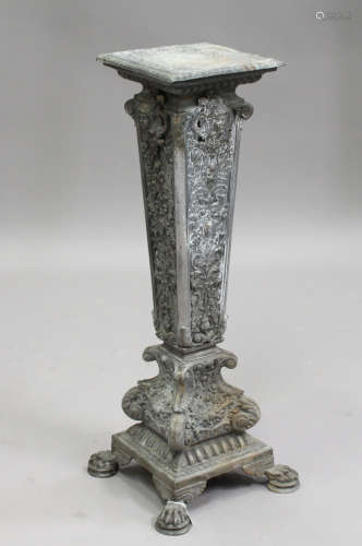 A late 19th/early 20th century cast metal pedestal, the tapering column cast with masks and scrolls,