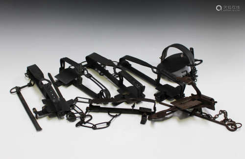 A large group of various wrought metal gin traps and other various forms of spring traps.Buyer’s