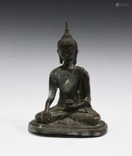 A 20th century South-east Asian bronzed copper model of a seated Buddha, height 20.5cm.Buyer’s
