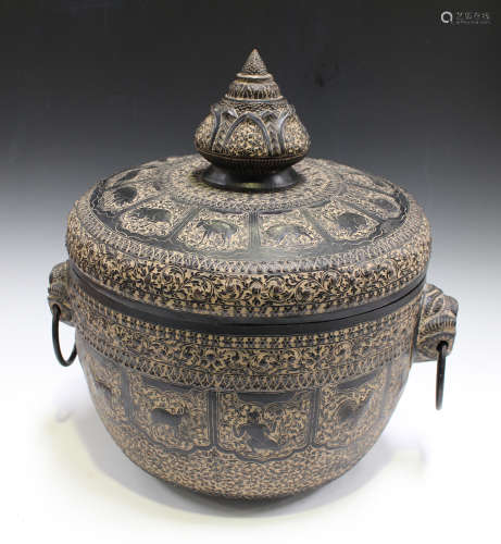 A 20th century Indian black patinated copper jar and cover, the top and sides worked with overall