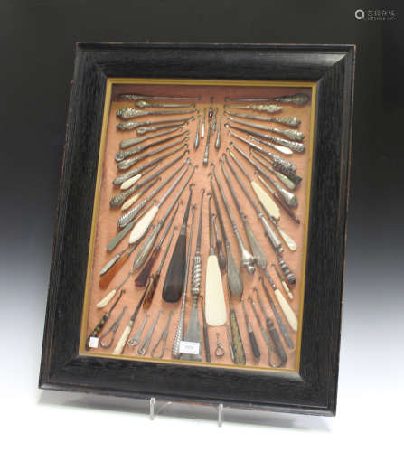 A large group of mainly late 19th century button hooks, including silver handled and folding