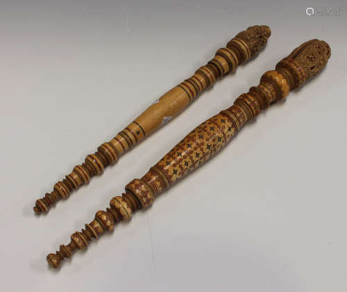 Two 19th century Indian turned and carved ivory fan handles, the stems with coloured detailing,