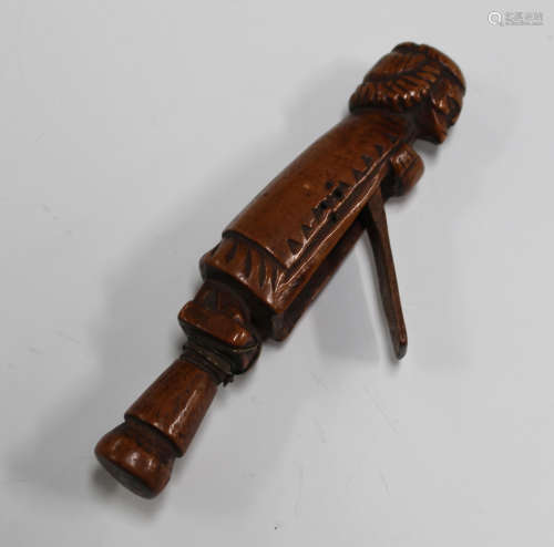 A 17th century carved treen combination pipe tamper snuff box, modelled in the form of a gentleman
