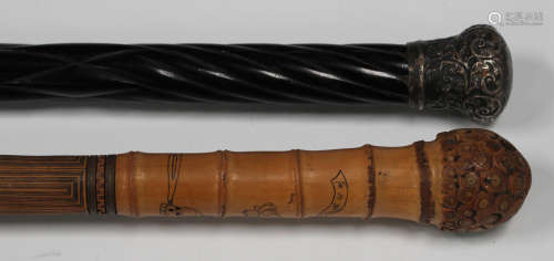 A late 19th/early 20th century Japanese bamboo walking stick, finely carved and incised with bands