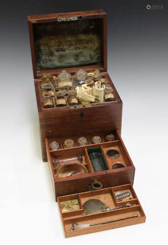 A George III mahogany apothecary's box, the hinged lid enclosing labelled glass bottles, the