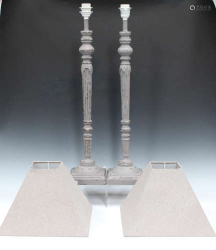 A pair of modern carved and painted table lamps with grey fabric shades, the reeded and fluted stems