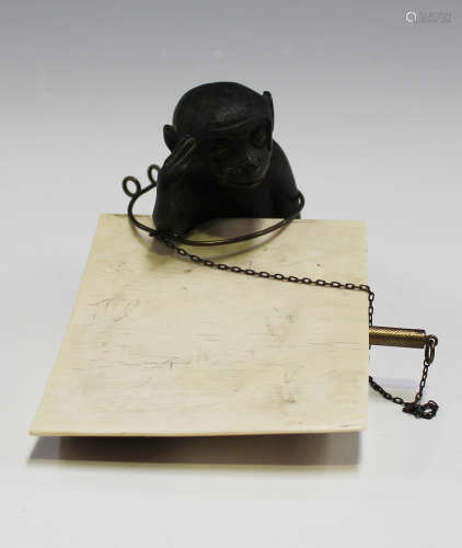 A late 19th/early 20th century dark brown patinated cast bronze and ivory aide-mémoire in the form