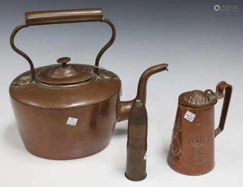A Victorian copper kettle with overhead handle, height 30cm, an Art Nouveau copper jug by J.S & S, a