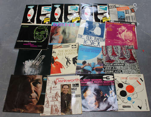 A collection of jazz LP records, including albums by Dave Brubeck, Johnny Dankworth and Louis