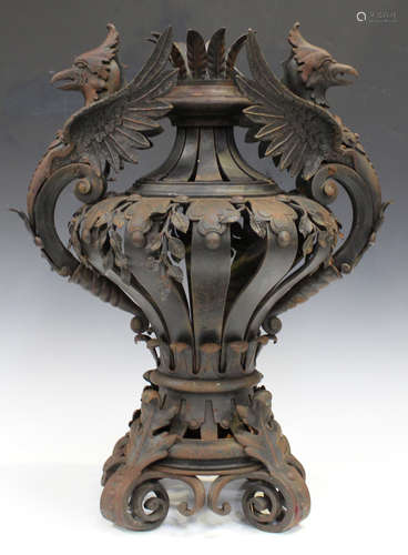 A 20th century French wrought iron ornamental urn, the strapwork baluster body with leaf mounts