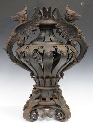 A 20th century French wrought iron ornamental urn, the strapwork baluster body with leaf mounts