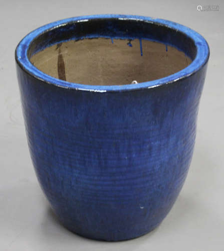 A large modern blue glazed earthenware garden urn of ribbed ovoid form, height 50cm, diameter 51cm.