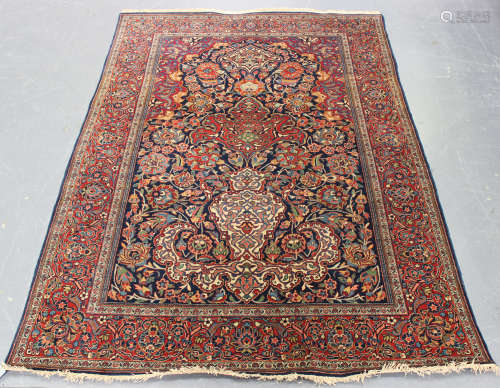 A Kashan prayer rug, Central Persia, early/mid-20th century, the ink blue mihrab with bold ascending