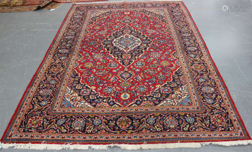 A Kashan carpet, Central Persia, mid-20th century, the red field with a shaped medallion,