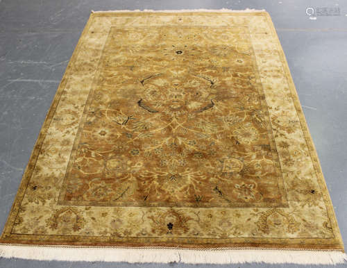 An Indian rug, late 20th century, the yellow field with overall scrolling tendrils, flowerheads