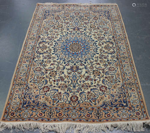 A Nain rug, Central Persia, late 20th century, the ivory field with a blue flowerhead medallion,