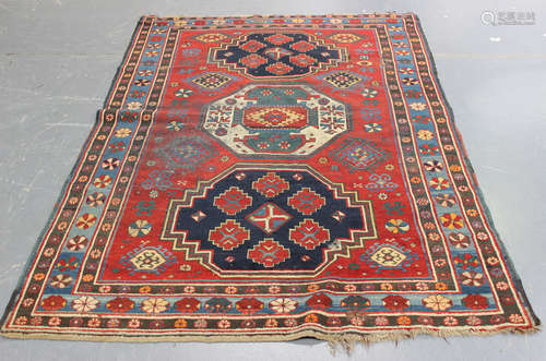 A Kazak rug, West Caucasus, early 20th century, the red field with three large medallions, supported