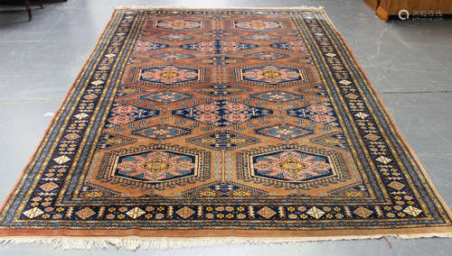 A Pakistan carpet, mid/late 20th century, the pink field with overall offset rows of lozenge