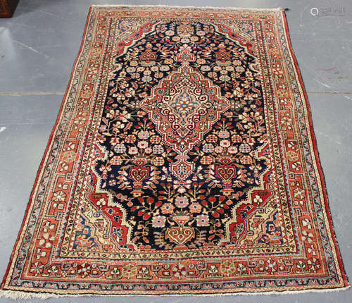 A Heriz rug, North-west Persia, early/mid-20th century, the midnight blue field with a shaped