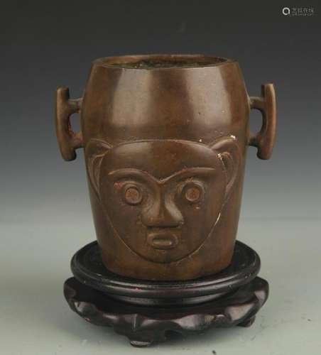 A BRONZE ANIMAL FACE BRONZE CENSER