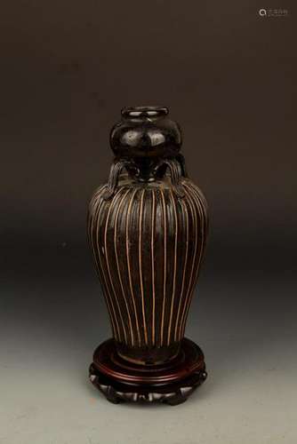 A BLACK COLOR, MELON-SHAPED PORCELAIN BOTTLE