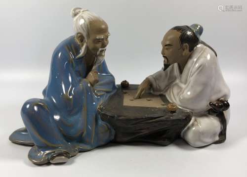 A CHINESE STONEWARE FIGURE GROUP OF TWO GAMES PLAYERS