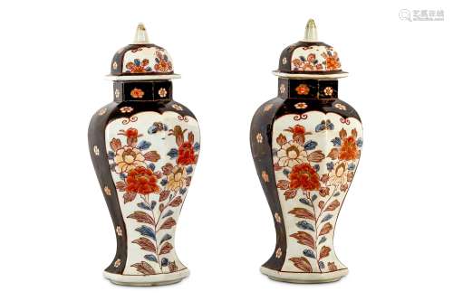 AN UNUSUAL PAIR OF JAPANESE IMARI VASES AND COVERS