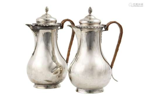 A pair of George V sterling silver hot water pots,