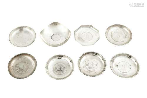 Eight silver coin or medallion set ashtrays, inducing a