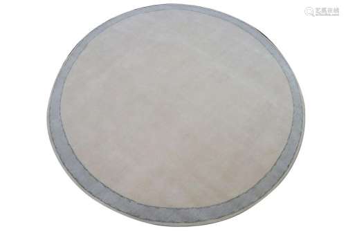 A large contemporary circular 100% wool carpet, light